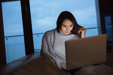 Sticker - Woman using laptop computer on the couch