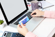 © Africa Studio - Concept for Internet shopping: hands with laptop and credit card