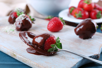 Sticker - A spoon and delicious strawberries in chocolate on wooden tablet