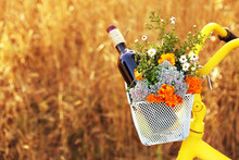 Bicycle With Flowers And Bottle Of Wine In Metal Basket Closeup, Outdoors