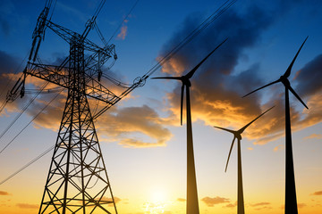 Wall Mural - high voltage tower and wind turbines against the sunset