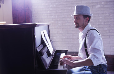 Sticker - Handsome young man in hat making piano music