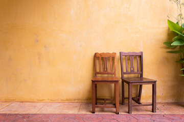 wooden chair and cement mortar wall background