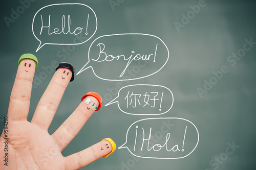 Four smiley fingers on a blackboard saying hello in English, French, Chinese and Spanish Tableau sur Toile