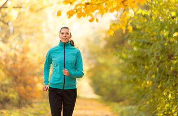 Wall Mural - Female fitness model training outside and running.