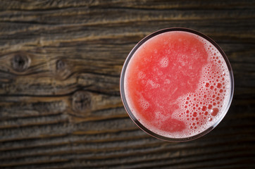 Sticker - Grapefruit juice over wooden table