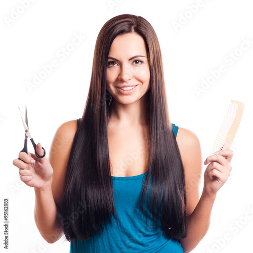 Fotografie, Tablou Closeup of a smiling young woman with beautiful hair, holding a pair of scissors
