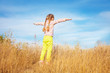 © murika - Little girl in bright clothes standing against the sky
