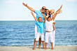 © Valua Vitaly - Smiling family with children having fun on the beach.