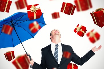 Poster - Composite image of happy businessman holding blue umbrella