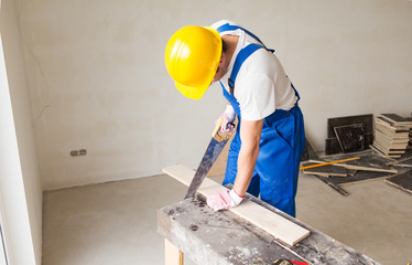 Poster - close up of builder with arm saw sawing board