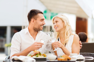 Poster - happy couple clinking glasses at restaurant lounge