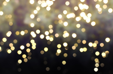 yellow and gold Bokeh Light and gradient shade to black color in Christmas Festival Central World,Bangkok