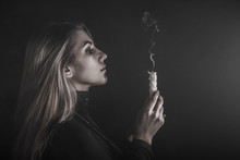 Young Woman Holding A Candle In A Smoke