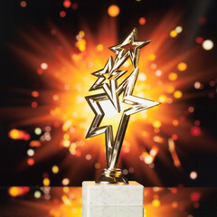 Wall Mural - gold stars trophy against shiny sparks background