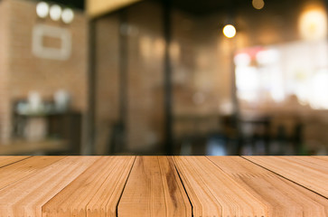 Selected focus empty brown wooden table and Coffee shop blur bac