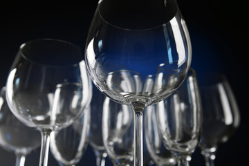 Poster - Empty wine glasses on blue background