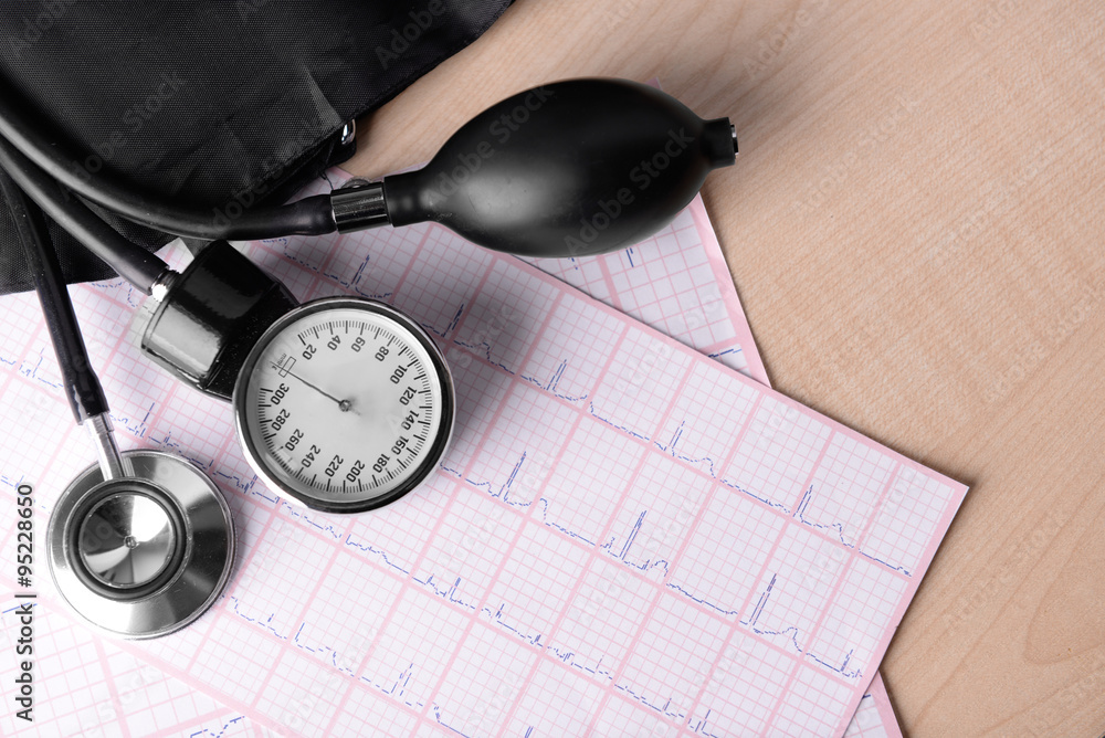 Blood pressure meter, digital tablet and stethoscope, on wooden background