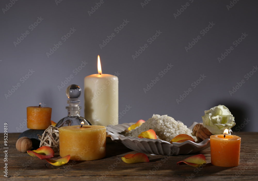 Beautiful spa composition with alight candles on wooden table
