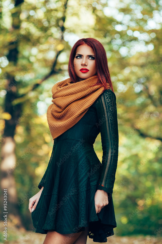 Attractive red-haired woman in a green dress posing in the park Stock Photo  | Adobe Stock
