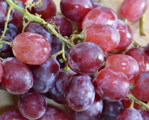 red grape on wooden chop plate