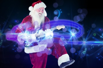 Canvas Print - Composite image of santa claus has fun with a guitar