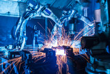 Fototapeta Tęcza -  Welding robots movement in a car factory