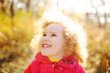 © Evgeniy Kalinovskiy - curly haired little girl playing on the autumn background