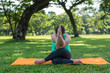 © Suttisak - Woman doing Yoga in the park