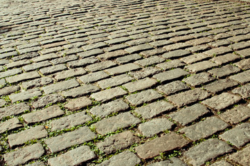 Sunlit pavement sett background texture