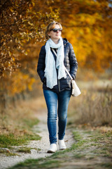 Wall Mural - middle-age woman walking in city park
