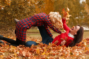 Two beautiful girls in autumn park