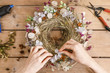 Woman making door wreath with autumn plants and flowers