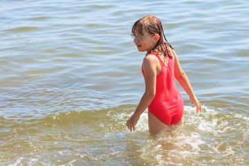 Little girl kid in sea water. Fun