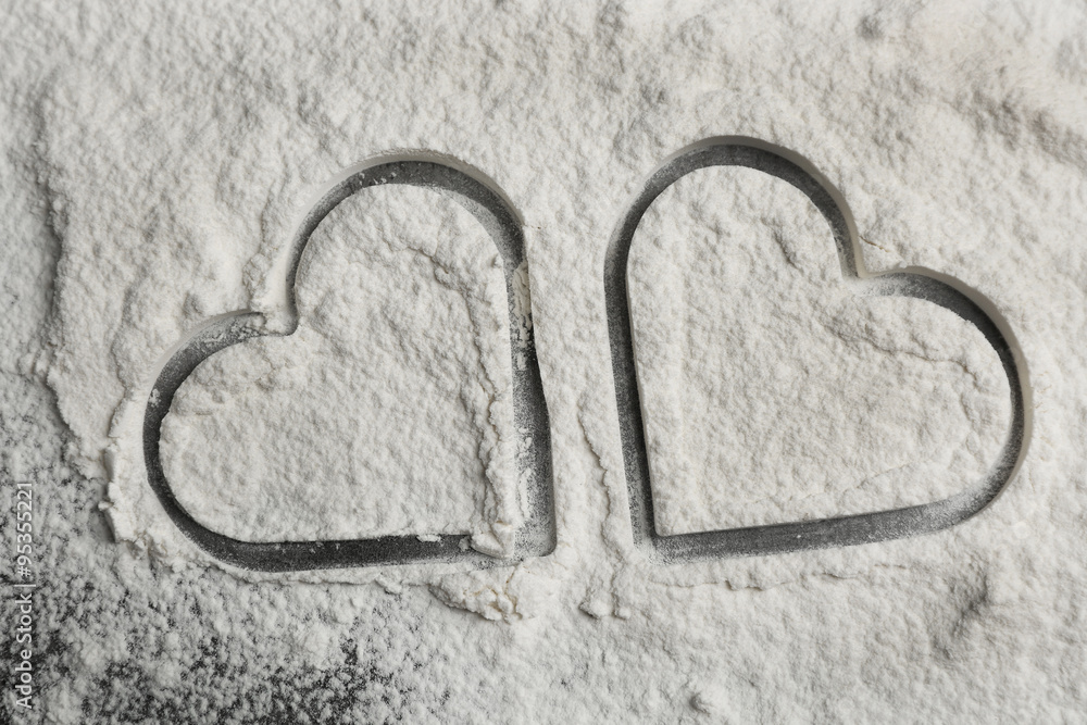 Hearts of flour on gray background