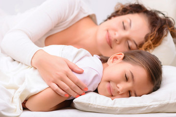 delighted mother and daughter sleeping