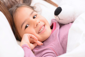 Little girl lying in bed 