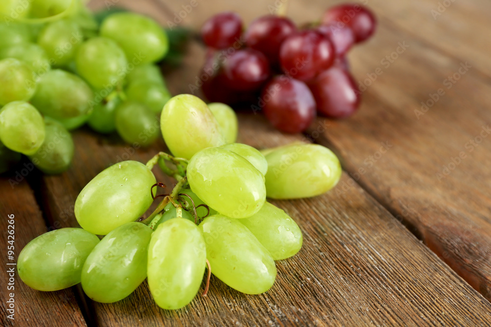White and red grape on wooden background