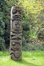 Weathered Totem Pole In Forest