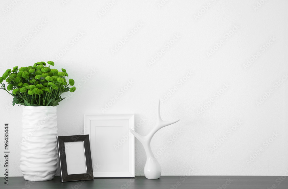 Beautiful green chrysanthemums in vase on commode in room