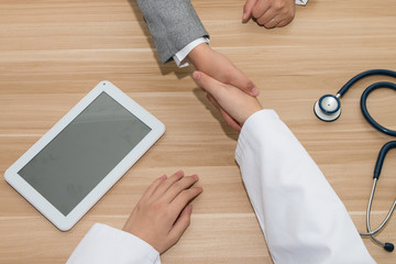 Wall Mural - Doctor and businessman shaking hands