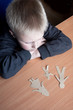 © mizina - Confused child with broken paper family