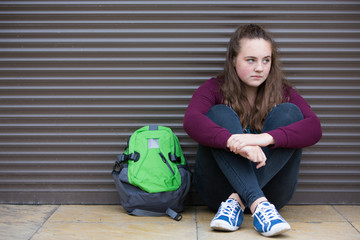 Homeless Teenage Girl On Streets With Rucksack