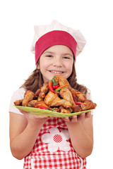 Wall Mural - happy little girl cook with roasted chicken drumstick on plate