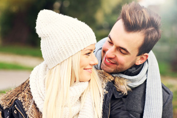 Wall Mural - Young happy couple in the park in autumn