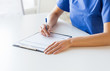 © Syda Productions - close up of doctor or nurse writing to clipboard