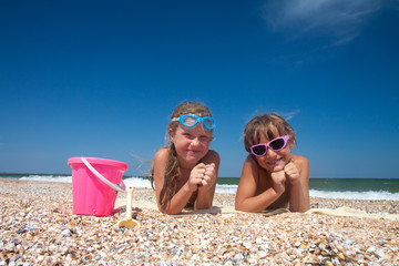 Two adorable toddler girl  on sand beach