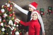 Happy child, boy and girl decorating a christmas tree