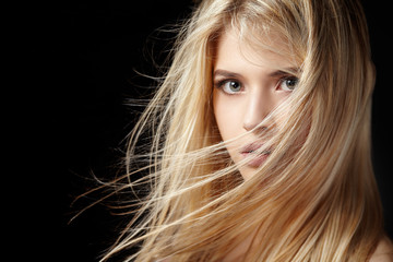 portrait of beautiful blonde woman with flying hair.