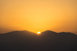 © viperagp - Scenic view of a beautiful rich orange sunset over the black silhouettes of the mountains